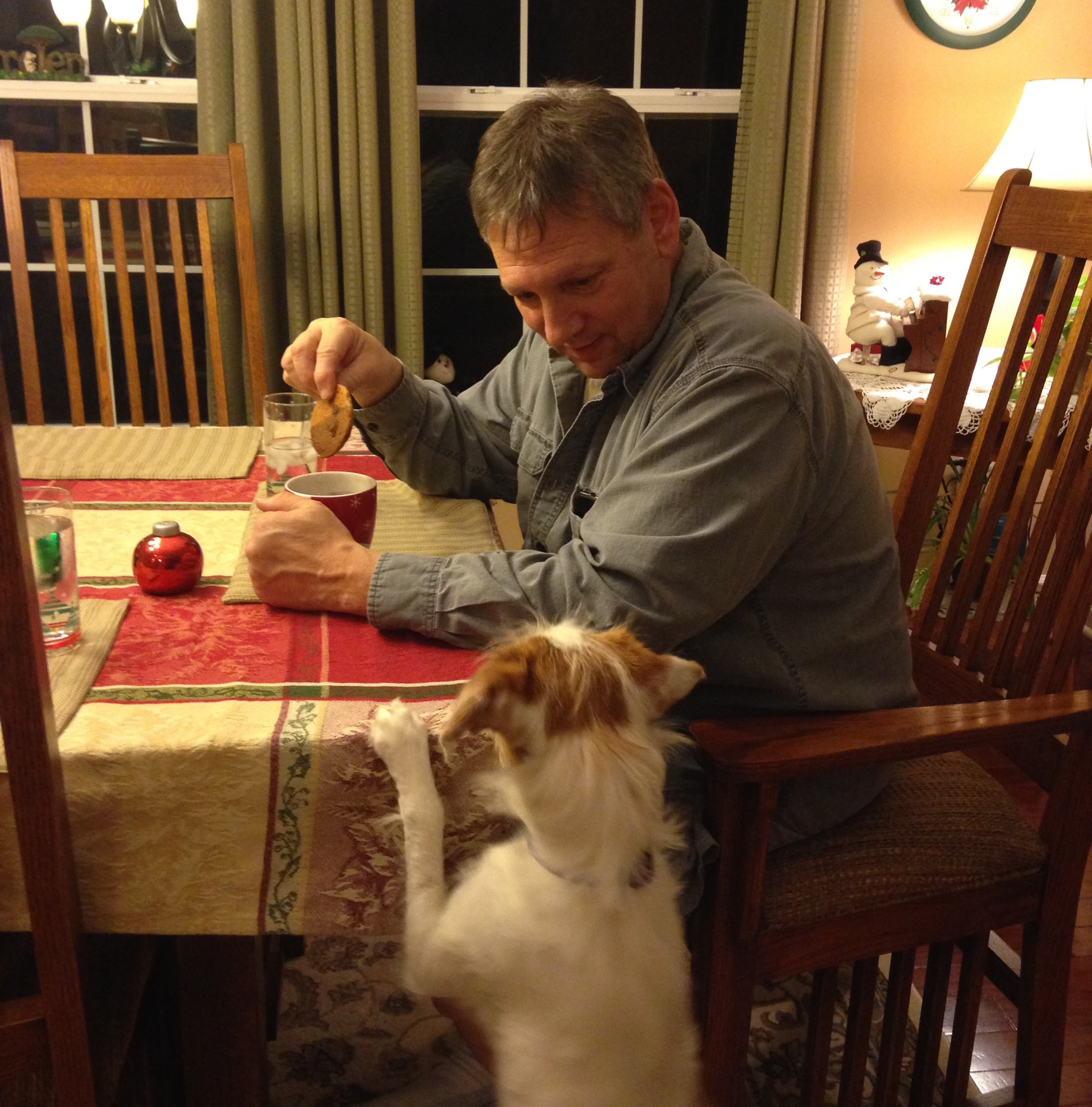 Dan being asked to provide a piece of ham by our dog.